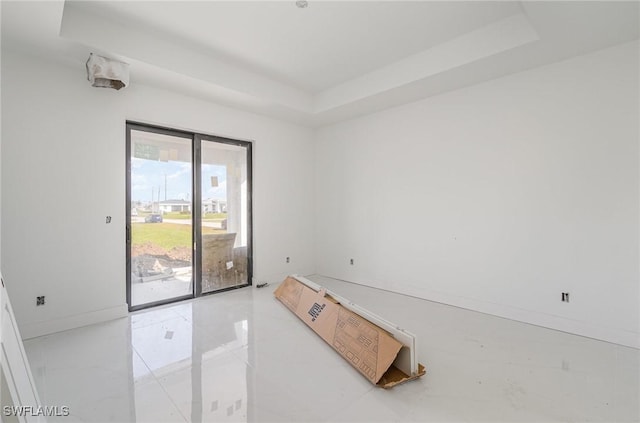 empty room featuring a tray ceiling