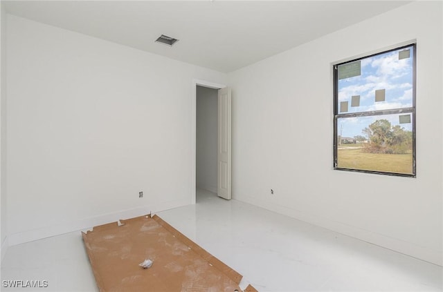 spare room featuring baseboards and visible vents