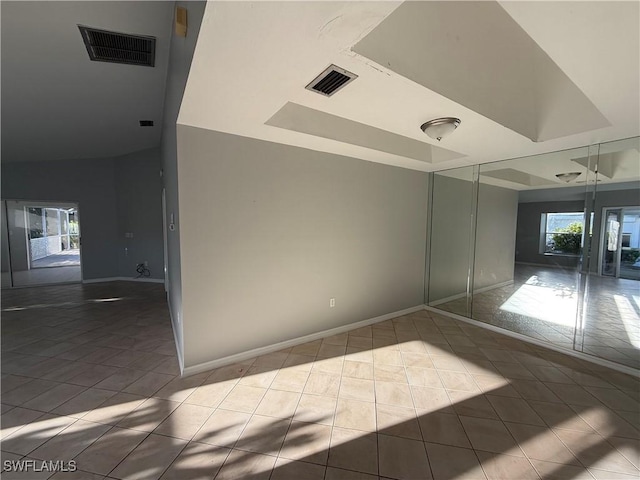 unfurnished bedroom with tile patterned floors, visible vents, baseboards, and a closet
