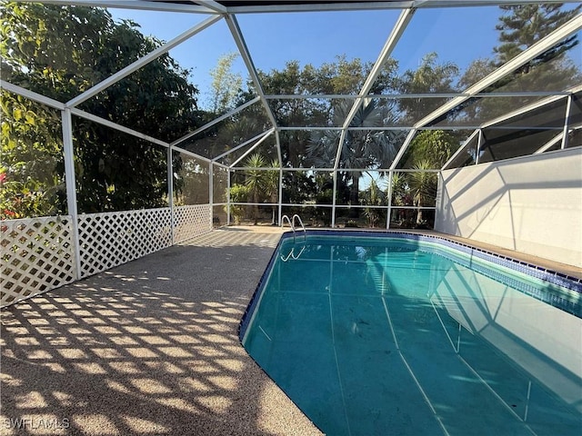 outdoor pool with a lanai and a patio area
