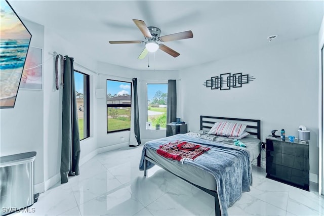 bedroom featuring a ceiling fan, baseboards, and marble finish floor