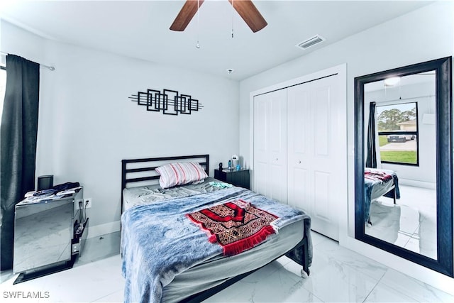 bedroom with visible vents, a ceiling fan, marble finish floor, and a closet