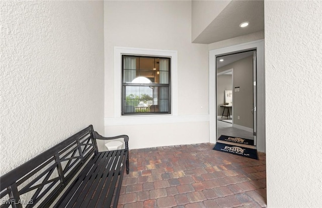 property entrance with stucco siding