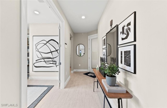 doorway with baseboards and recessed lighting