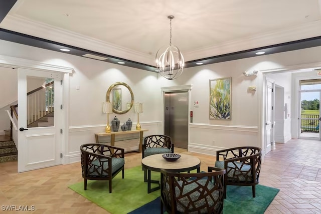 living area featuring crown molding, a chandelier, and elevator