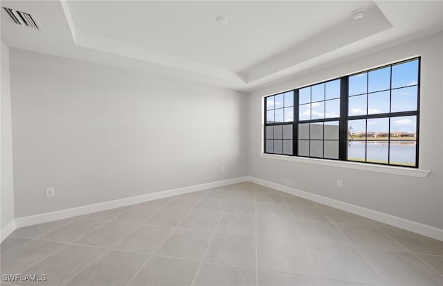 16740 Rolling Rock Blvd, Alva, FL 33920 - spare room featuring a raised ceiling, baseboards, light tile patterned floors, and a water view
