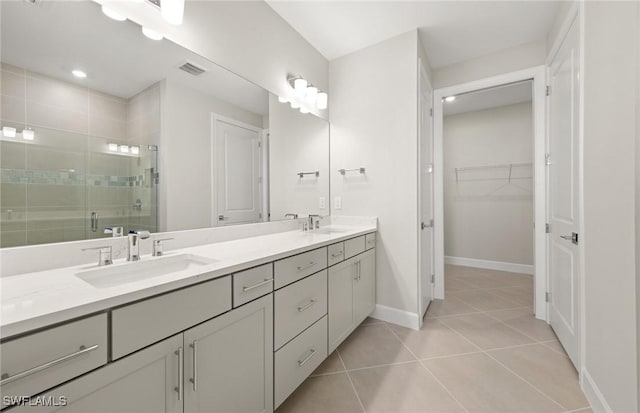 16740 Rolling Rock Blvd, Alva, FL 33920 - bathroom with a stall shower, tile patterned flooring, double vanity, baseboards, and a walk in closet