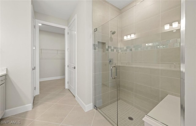 16740 Rolling Rock Blvd, Alva, FL 33920 - bathroom featuring a stall shower, baseboards, tile patterned floors, vanity, and a walk in closet