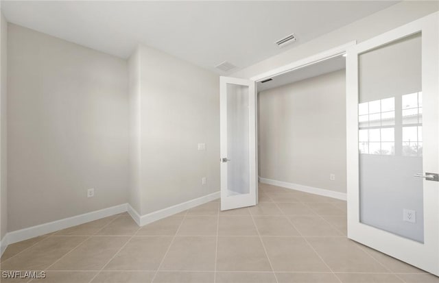 16740 Rolling Rock Blvd, Alva, FL 33920 - unfurnished bedroom featuring light tile patterned floors, baseboards, and french doors