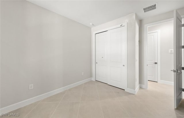 16740 Rolling Rock Blvd, Alva, FL 33920 - unfurnished bedroom featuring baseboards, light tile patterned flooring, and a closet