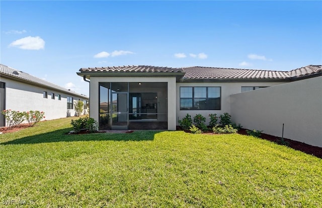 16740 Rolling Rock Blvd, Alva, FL 33920 - rear view of property with a tiled roof, a sunroom, a lawn, and stucco siding
