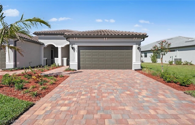 16740 Rolling Rock Blvd, Alva, FL 33920 - mediterranean / spanish home featuring decorative driveway, stucco siding, an attached garage, and a tile roof