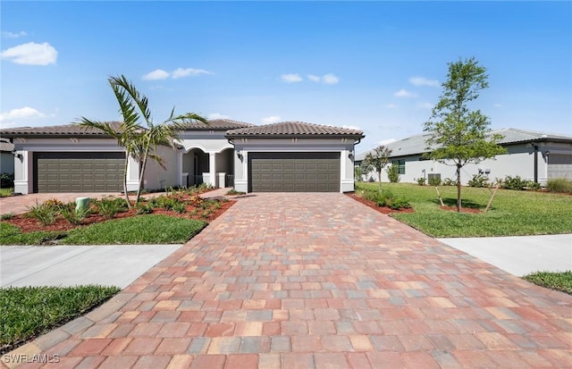 16740 Rolling Rock Blvd, Alva, FL 33920 - mediterranean / spanish home featuring a garage, decorative driveway, a tile roof, and stucco siding