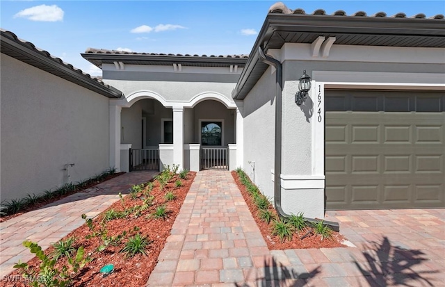 16740 Rolling Rock Blvd, Alva, FL 33920 - entrance to property featuring stucco siding, a garage, and a tile roof