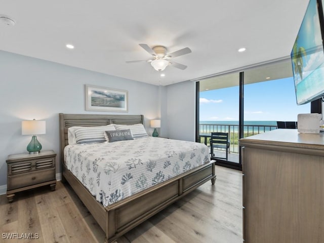 bedroom with ceiling fan, access to exterior, expansive windows, baseboards, and light wood-style floors
