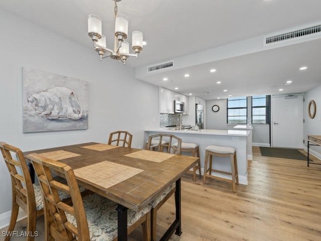 dining space with visible vents, recessed lighting, baseboards, and light wood-type flooring