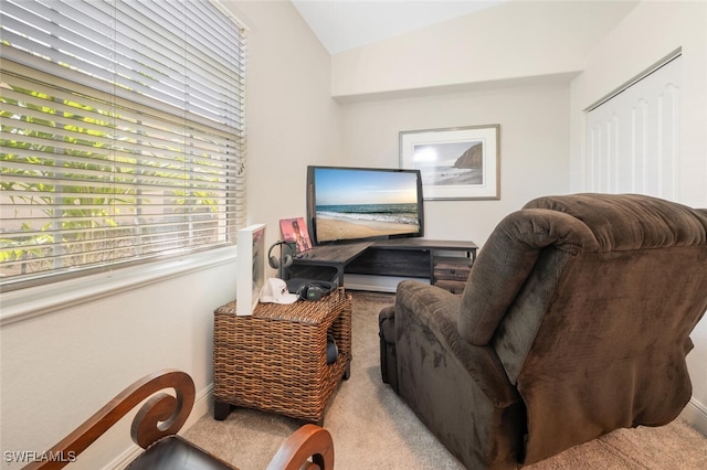 carpeted home office featuring vaulted ceiling and baseboards
