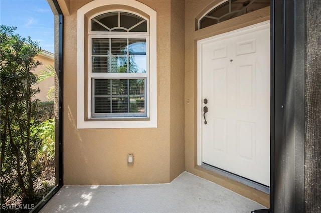 doorway to property with stucco siding
