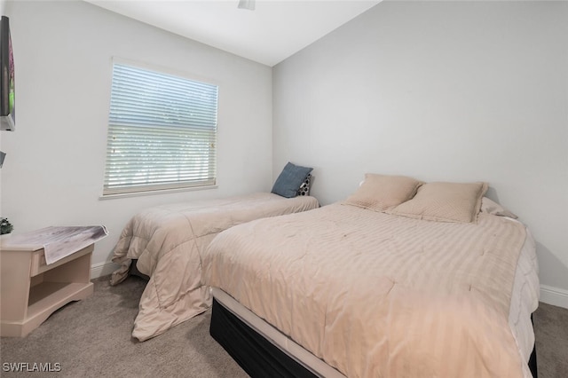 carpeted bedroom featuring baseboards