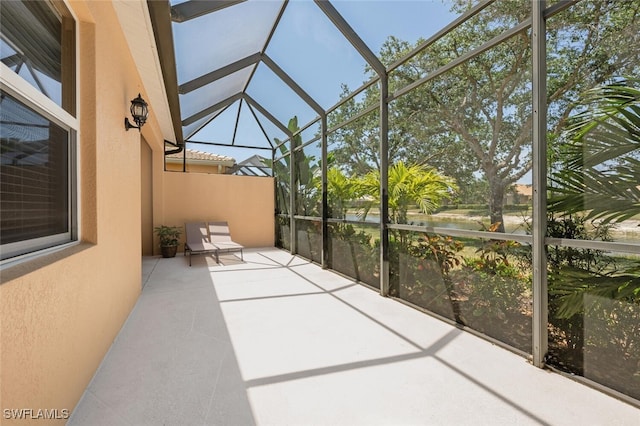 unfurnished sunroom featuring vaulted ceiling