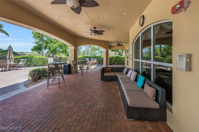 view of patio featuring outdoor dining area, ceiling fan, fence, and outdoor lounge area
