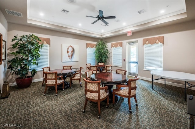 dining area featuring a raised ceiling, dark colored carpet, baseboards, ceiling fan, and recessed lighting