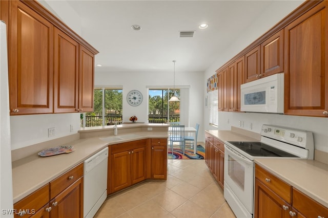 14572 Bellino Ter Unit 202, Bonita Springs, FL 34135 - kitchen featuring white appliances, a sink, brown cabinets, and recessed lighting