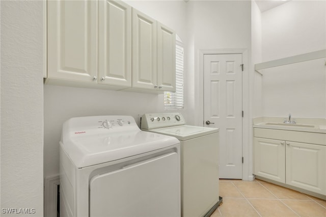 14572 Bellino Ter Unit 202, Bonita Springs, FL 34135 - clothes washing area with separate washer and dryer, cabinet space, and light tile patterned floors