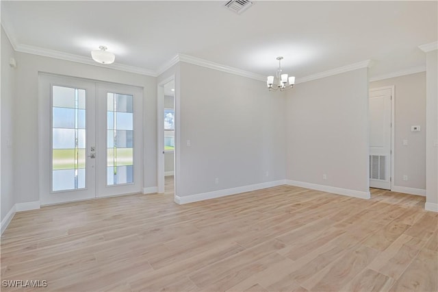 unfurnished room featuring a notable chandelier, light wood-style floors, plenty of natural light, french doors, and visible vents