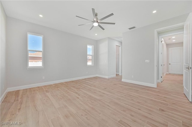 interior space with a healthy amount of sunlight, ceiling fan, light wood-style floors, and visible vents