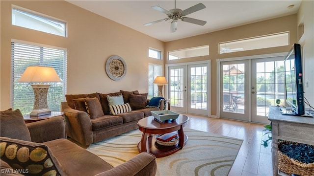 living room with french doors, ceiling fan, and hardwood / wood-style flooring