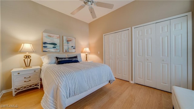 bedroom with multiple closets, ceiling fan, and light wood-style flooring