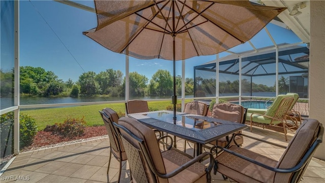 sunroom featuring outdoor dining area and a water view