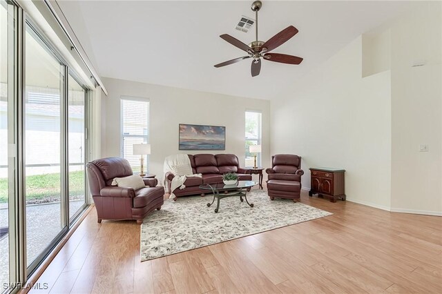 23061 Grassy Pine Dr, Estero, FL 33928 - living room featuring visible vents, baseboards, ceiling fan, high vaulted ceiling, and light wood-style flooring