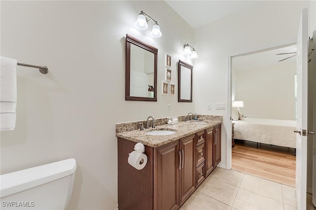 23061 Grassy Pine Dr, Estero, FL 33928 - ensuite bathroom featuring toilet, a sink, tile patterned flooring, and ensuite bath