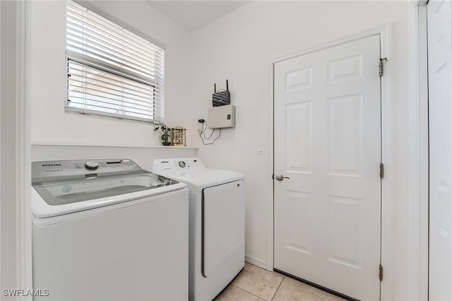 23061 Grassy Pine Dr, Estero, FL 33928 - clothes washing area featuring washer and dryer, light tile patterned flooring, and laundry area