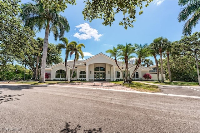23061 Grassy Pine Dr, Estero, FL 33928 - view of front facade with stucco siding and french doors