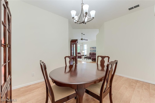 23061 Grassy Pine Dr, Estero, FL 33928 - dining room featuring baseboards, visible vents, light wood finished floors, and ceiling fan with notable chandelier