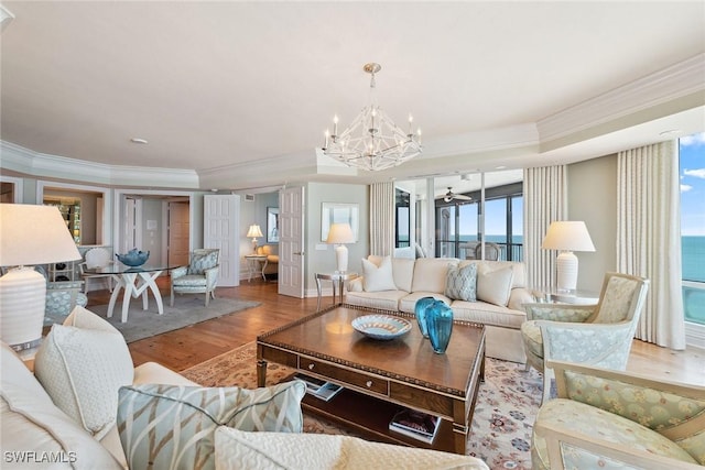8477 Bay Colony Dr Unit 1102, Naples, FL 34108 - living room featuring baseboards, ornamental molding, ceiling fan with notable chandelier, and wood finished floors