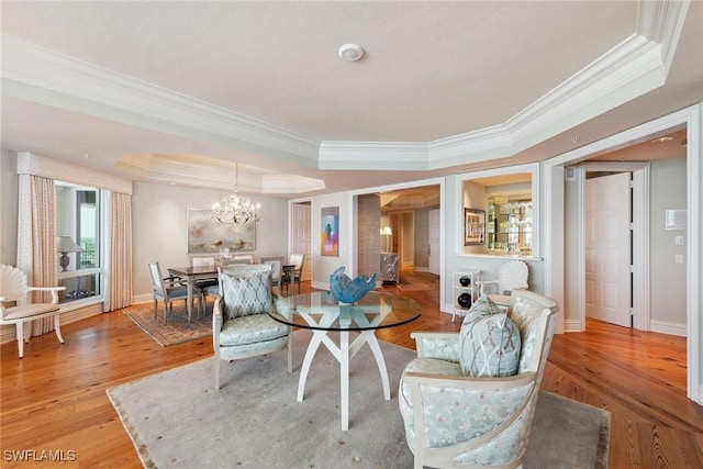 8477 Bay Colony Dr Unit 1102, Naples, FL 34108 - interior space featuring crown molding, a raised ceiling, a chandelier, baseboards, and light wood-type flooring
