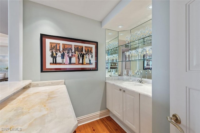 8477 Bay Colony Dr Unit 1102, Naples, FL 34108 - bathroom featuring baseboards, wood finished floors, and vanity