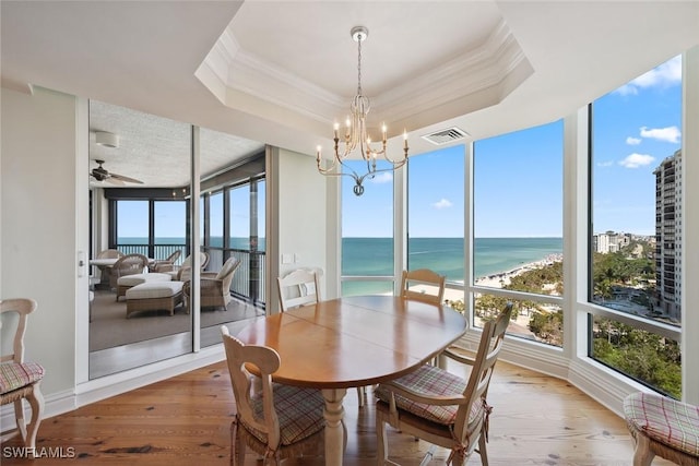 8477 Bay Colony Dr Unit 1102, Naples, FL 34108 - sunroom featuring visible vents, ornamental molding, wood finished floors, a water view, and a chandelier
