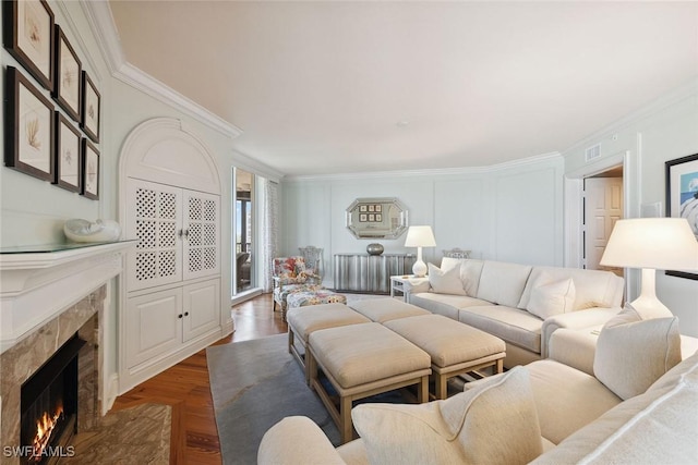 8477 Bay Colony Dr Unit 1102, Naples, FL 34108 - living area featuring ornamental molding, dark wood finished floors, visible vents, and a premium fireplace