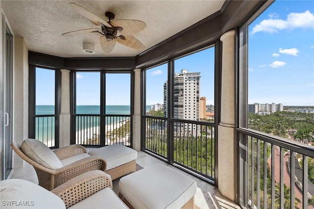 8477 Bay Colony Dr Unit 1102, Naples, FL 34108 - sunroom with a ceiling fan, a textured ceiling, and a water view
