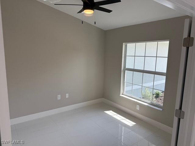 empty room featuring baseboards and ceiling fan