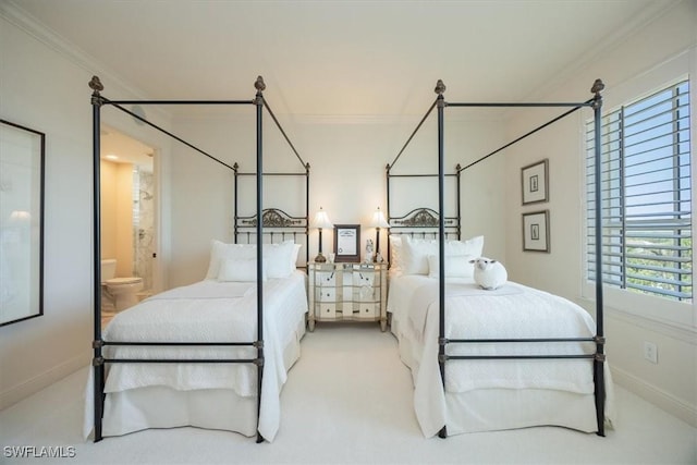 bedroom featuring ornamental molding, carpet floors, connected bathroom, and baseboards