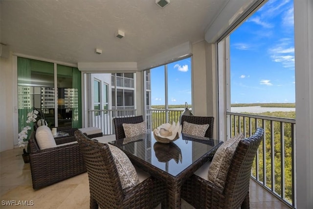 sunroom featuring plenty of natural light and tile patterned flooring