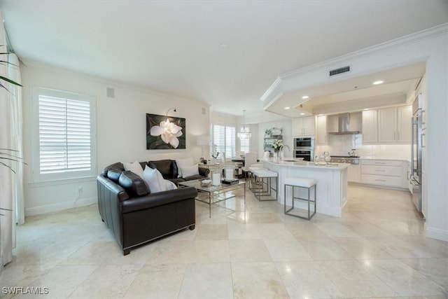 living area with crown molding, baseboards, light tile patterned floors, and recessed lighting