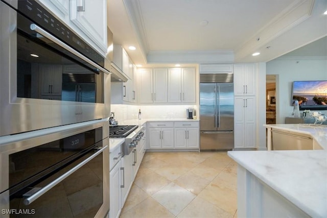kitchen featuring appliances with stainless steel finishes, crown molding, white cabinetry, light countertops, and recessed lighting