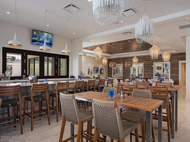 dining space with a chandelier, recessed lighting, and light tile patterned floors